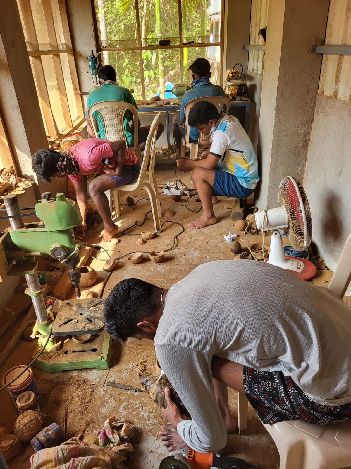 Artisan crafting coconut shell product in Guhagar workshop